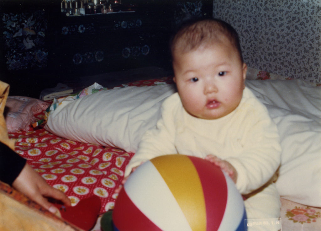 Yoonseon as a baby holding a ball