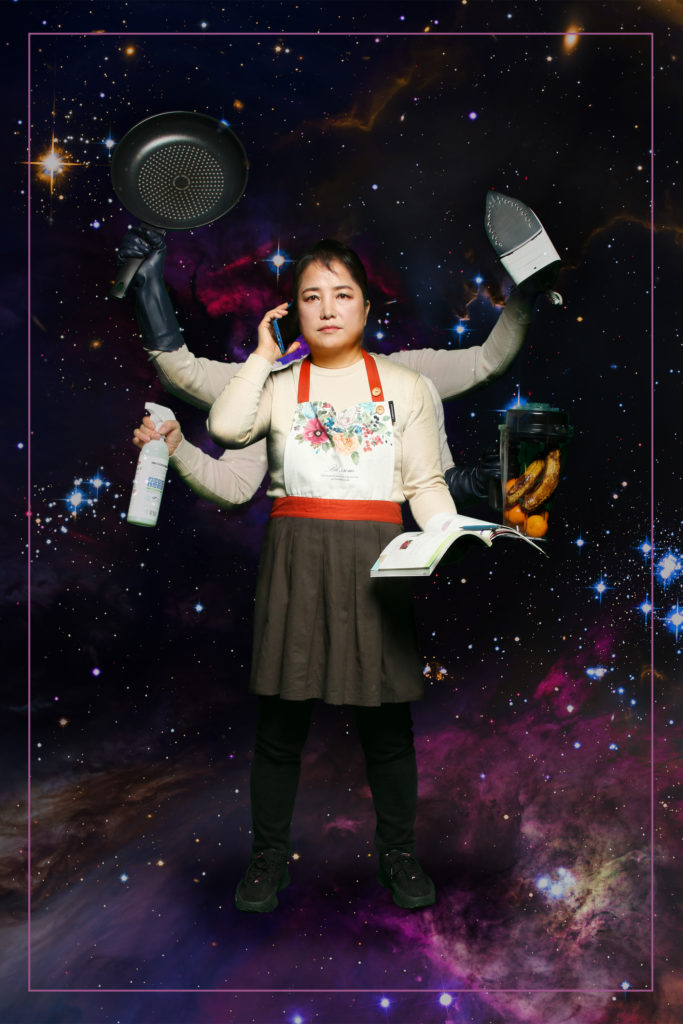 Yeonsu in an apron with 6 arms, each holding a domestic item with a dark galaxy background
